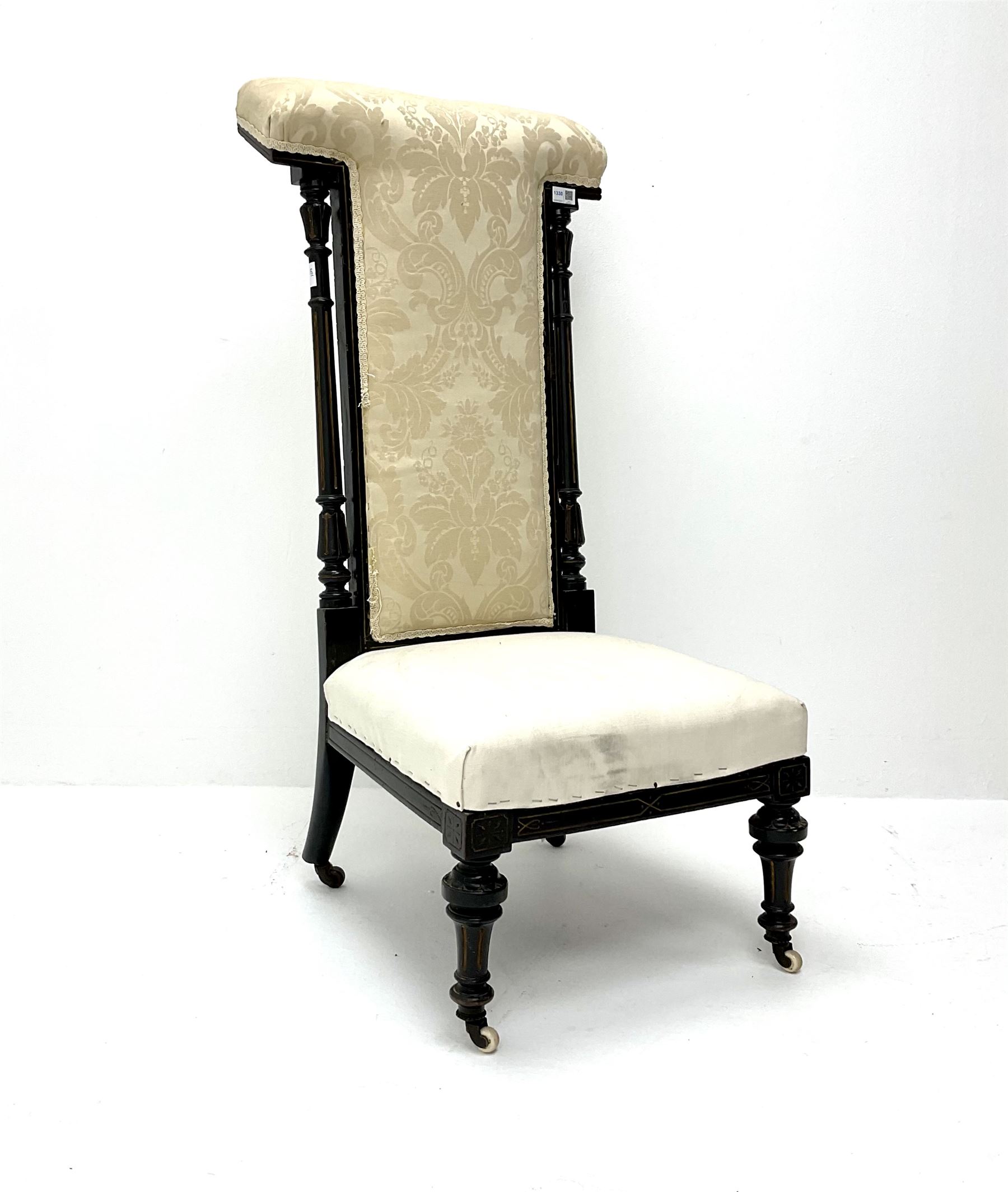 Victorian ebonised prie dieu chair upholstered in an ivory ground fabric, turned reeded and tapering supports