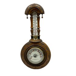 An Edwardian hall barometer with a compensated Aneroid movement by the German maker Julius Gischard, porcelain four-and-a-half-inch register measuring barometric air pressure from twenty-six to thirty-one point nine inches, weather predictions written in upper and lower case gothic script with initial letters highlighted in red, blue steel indicating hand and brass recording hand, dial bezel with flat bevelled glass, spirit thermometer recording temperature in degrees Fahrenheit and Celsius on an unglazed opal plate with arched crest above, Dial inscribed “Wooley & Sons Manchester”.
H46cm    


