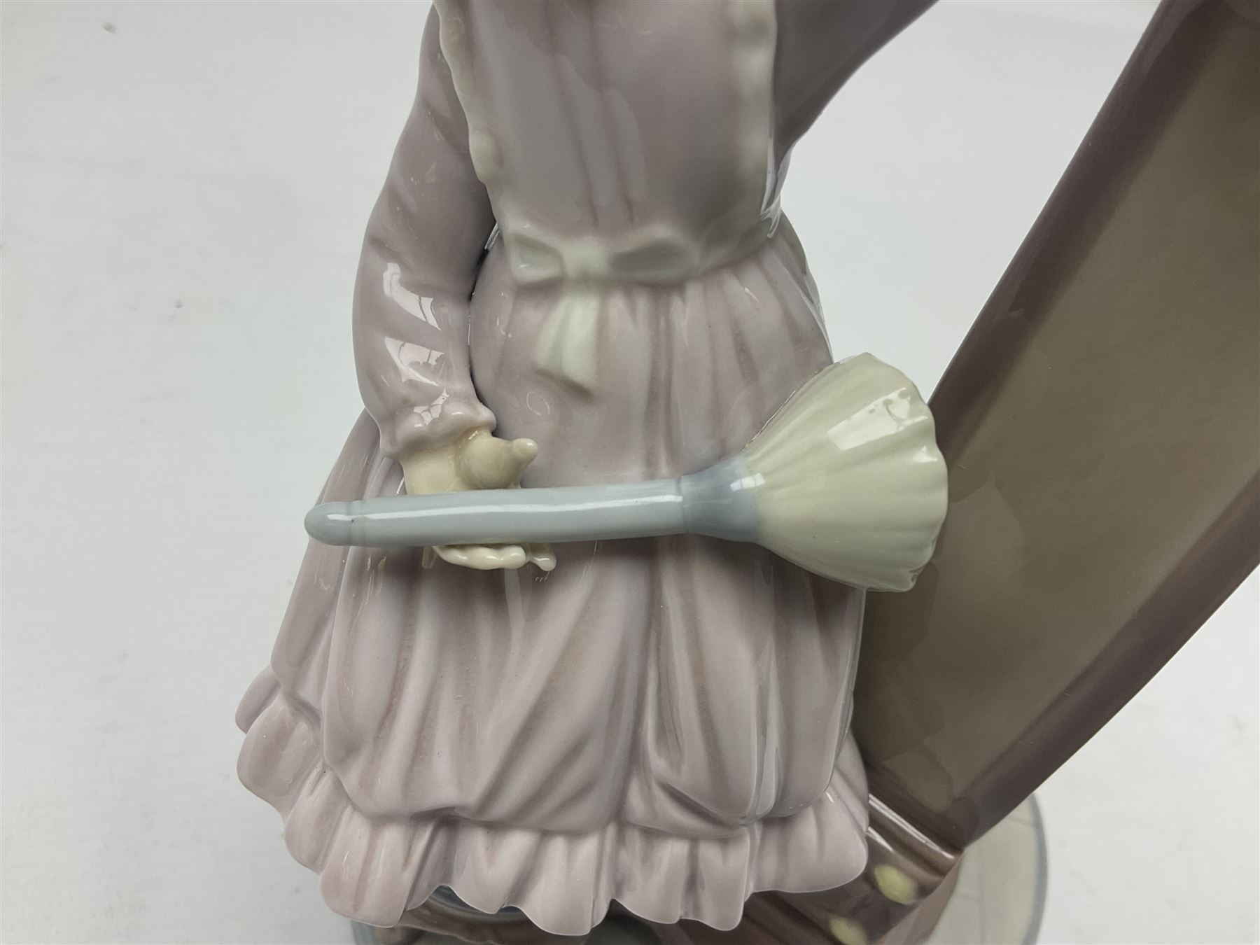 Lladro figure, Bedtime, modelled as a young girl reaching for her pet cat upon grandfather clock, sculpted by Vincente Martinez, with original box, no 5347, year issued 1986, year retired 1998, H28cm
