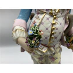 Large pair of late 19th century Continental figures in the Meissen style, modelled as a gardener and companion in 18th century dress, holding baskets of flowers and posies, each upon naturalistically modelled floral encrusted square base with scroll moulded sides, with underglaze blue cross sword type marks beneath, tallest example H49cm