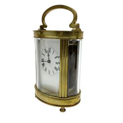 Two French early 20th century timepiece carriage clocks and a traveling case, both clocks with enamel dials, Roman numerals and steel hands, both with cylinder platform escapements.