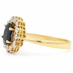 18ct gold sapphire and diamond cluster ring, single oval cut sapphire of approx 1.05 carat, surrounded by twelve round brilliant cut diamonds, stamped 750, total diamond weight approx 0.25 carat