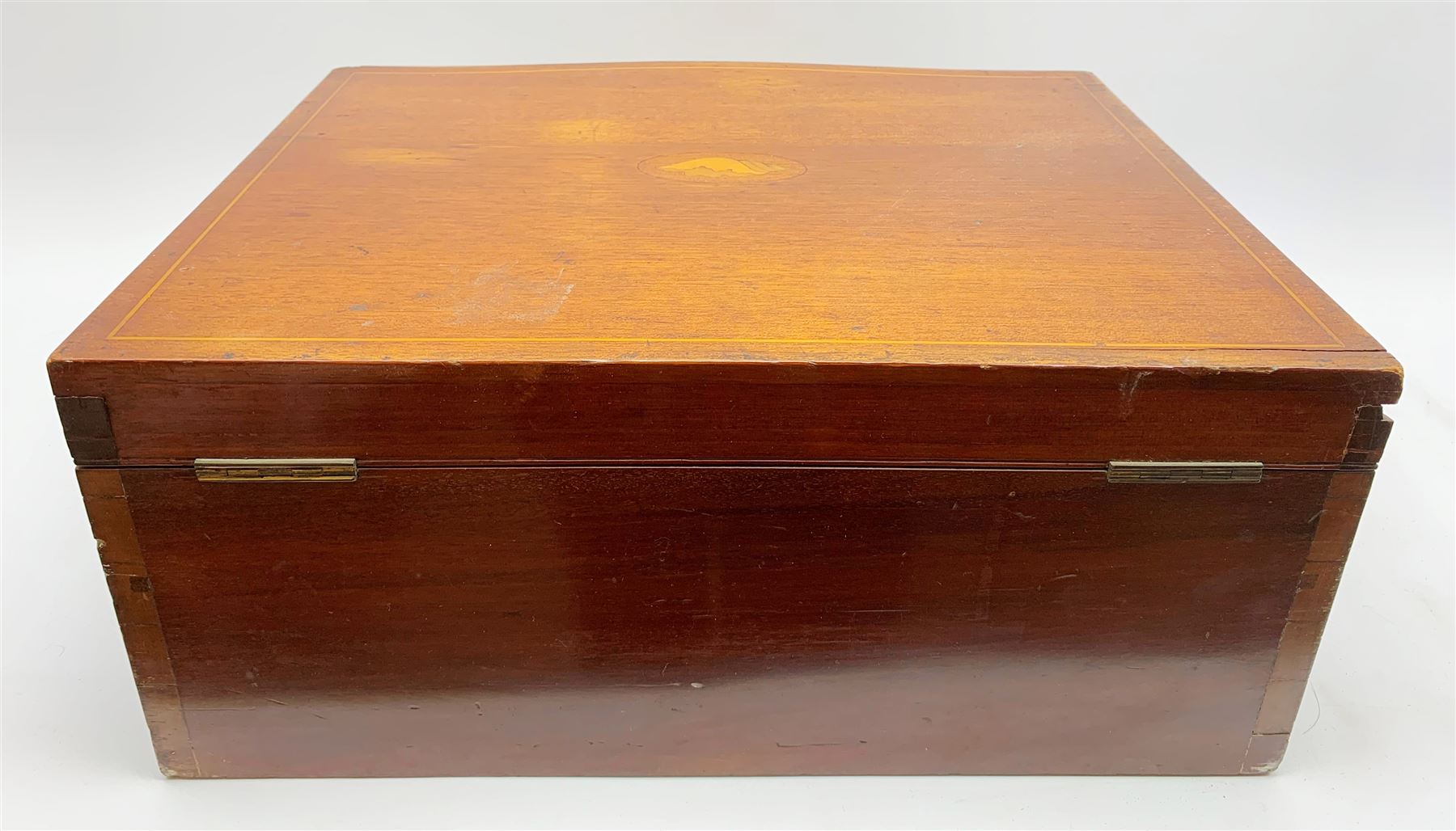 Late 19th/early 20th century composite canteen of silver flatware, contained within an early 20th century mahogany serpentine fronted case with twin drop carry handles, and hinged cover with boxwood stringing and central inlaid shell motif, above a single drawer with twin ring handles and Wellington style locking system, the cover and drawer opening to reveal plaque for Spink & Sons Ltd London, and fitted interior containing ivory handled knives, ivory handled carving set, and silver Hanoverian and Old English pattern cutlery, each with engraved monogram to terminal, hallmarked London, makers Spink & Son (John Marshall Spink), Goldsmiths & Silversmiths Co, and Chawner & Co (George William Adams), various dates ranging 1880-1923, gross weighable silver 92.59 ozt (2880 grams)