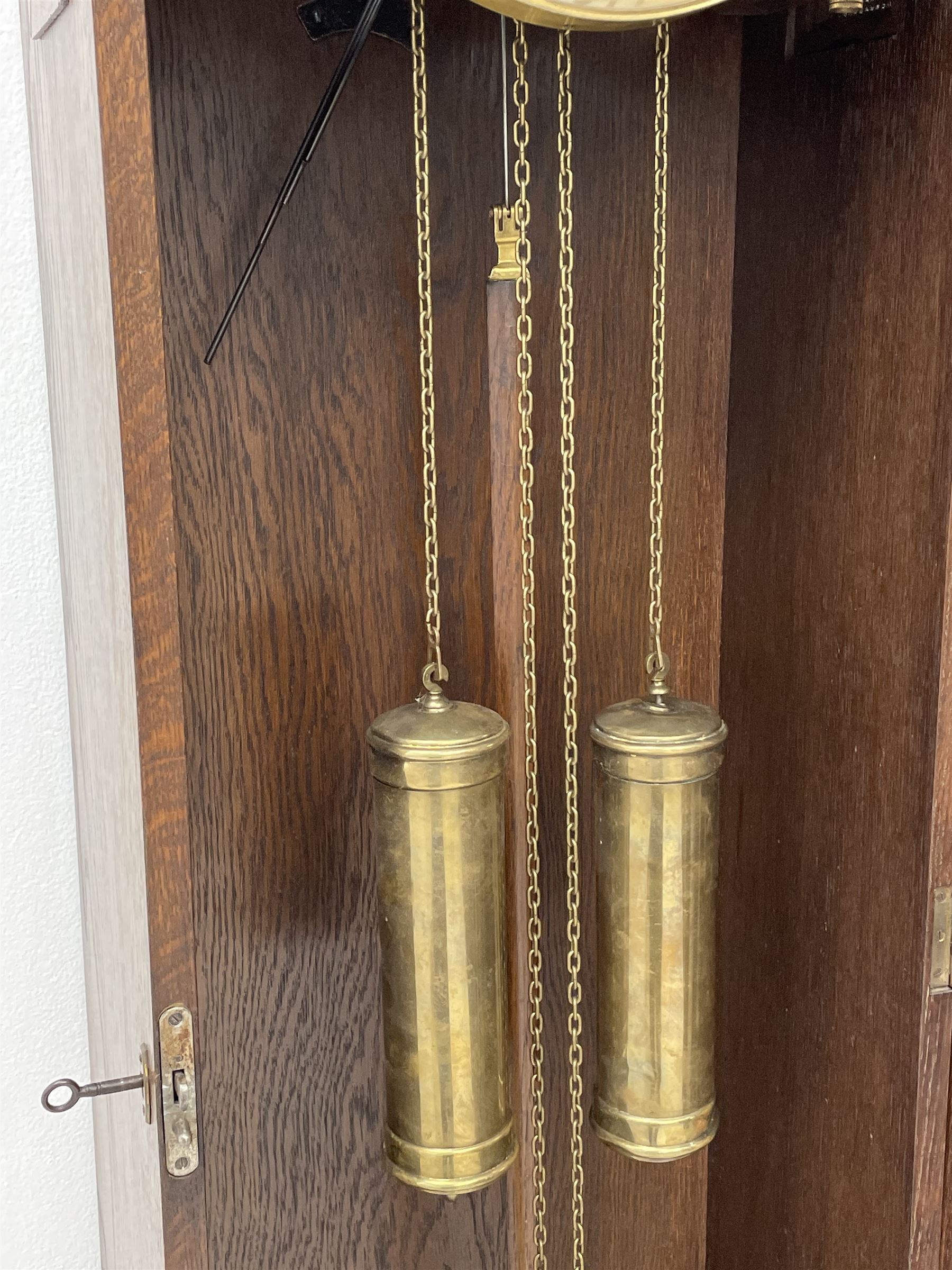 Early 20th century Art Deco oak longcase clock, circular dial with roman numerals and minute track, dial signed 'Barnby & Rust, Hull', twin chain driven movement striking the hours on gong rods. With weights and Pendulum.