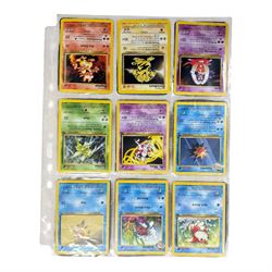 Collection of mainly vintage Pokemon cards including Charizard Base Set Holographic number 4/102 and two Ancient Mew 2000 promo cards, some housed within plastic wallets and some loose
