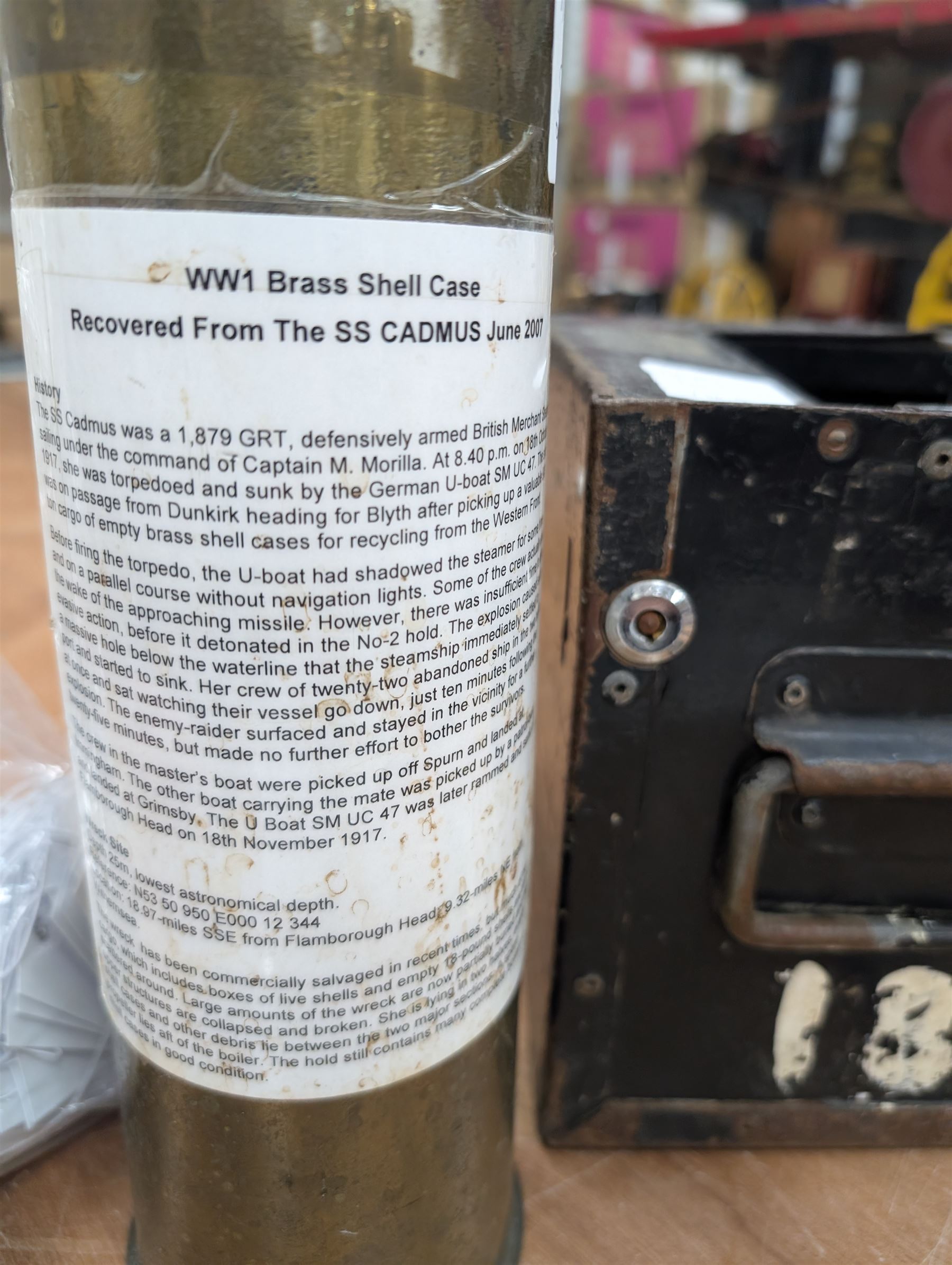 WWI brass shell case, by vendor repute salvaged from SS Cadmus wreckage site June 2007 off Flamborough Head, together with a reproduction RMS Lusitania medal in box and a metal tin