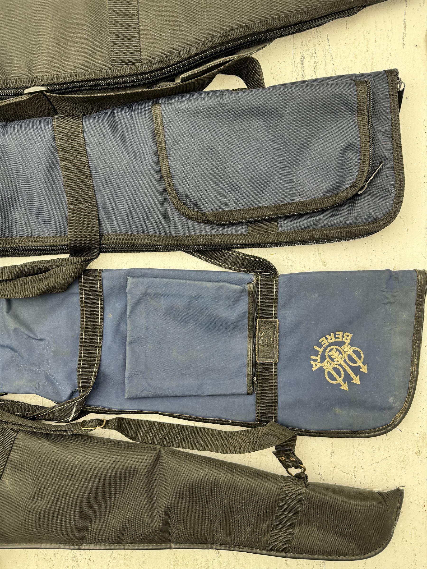 Collection of gun slips, including BSA guns and napier examples and leather 12-bore cartridge belt 