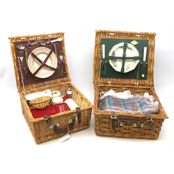A wicker Amberley picnic basket, together with a wicker Optima example, each with contents. (2). 