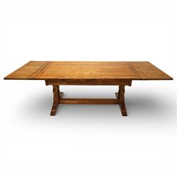 Late 20th century light oak extending refectory table, in the manner of Titchmarsh & Goodwin, rectangular plank top with cleated ends and two draw leaves extending to 260cm, supported on turned end supports united by a stretcher, raised on block feet