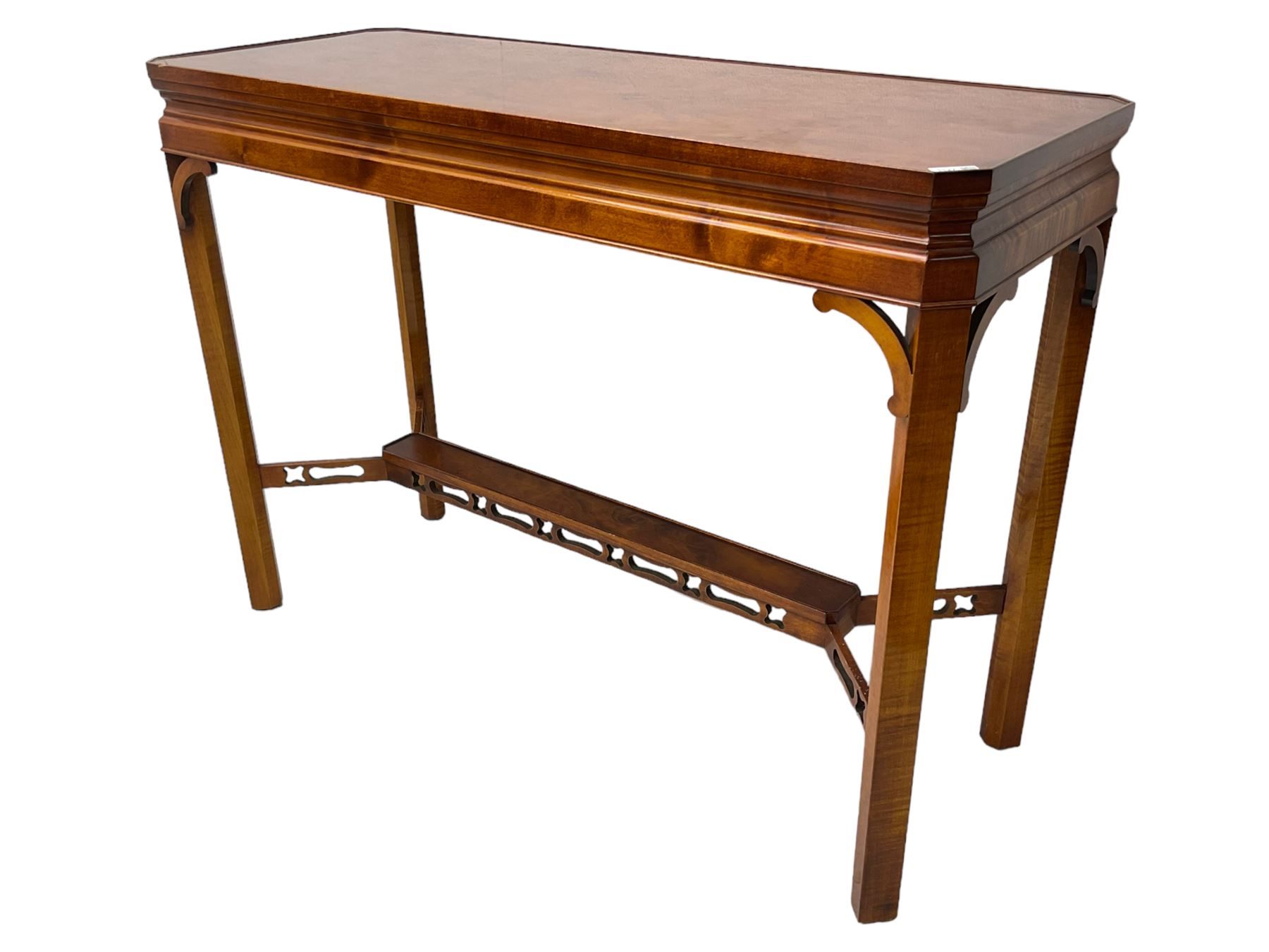 Wade - yew wood console table, rectangular top with canted corners and raised lipped edge, on chamfered square supports united by narrow under-tier