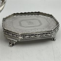 Victorian silver four piece tea service, comprising teapot, teapot stand, twin handled open sucrier and milk jug, each of octagonal form with foliate bud border and engraved decoration including crest to canted panels, and vacant panels, the teapot with ivory finial to the hinged cover and later wooden handle, hallmarked Edward Barnard & Sons Ltd, London1896, teapot including finial H15cm, milk jug including handle H16cm, teapot stand W11.5cm

This item has been registered for sale under Section 10 of the APHA Ivory Act