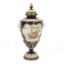 Late 19th century Royal Worcester porcelain vase and cover, circa 1897, of baluster form with twin lion masks to shoulders, painted with a reserve of exotic birds within a landscape, against a blue scale ground with gilt highlights, and further detailed with smaller reserves containing butterflies, the shoulder, base of body and foot with moulded acanthus bands, upon a circular spreading foot, with green printed marks beneath including shape number 2305 and Rd no 419210, H27.5cm