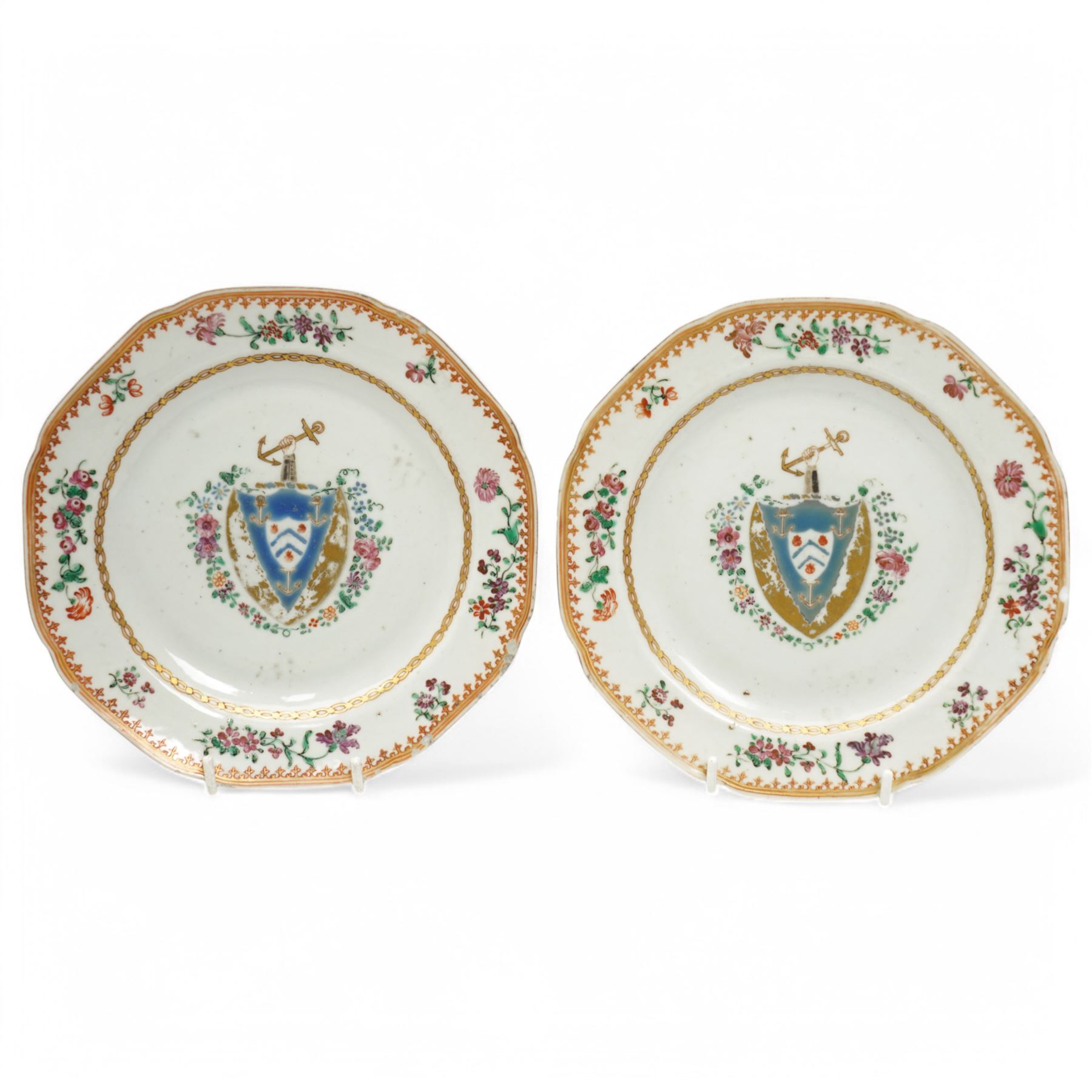 Chinese export Armorial part service decorated with sprays of flowers and a crest of an arm holding an anchor comprising bowl D23cm, pair of octagonal plates 16cm and sparrow beak jug H12cm (4)