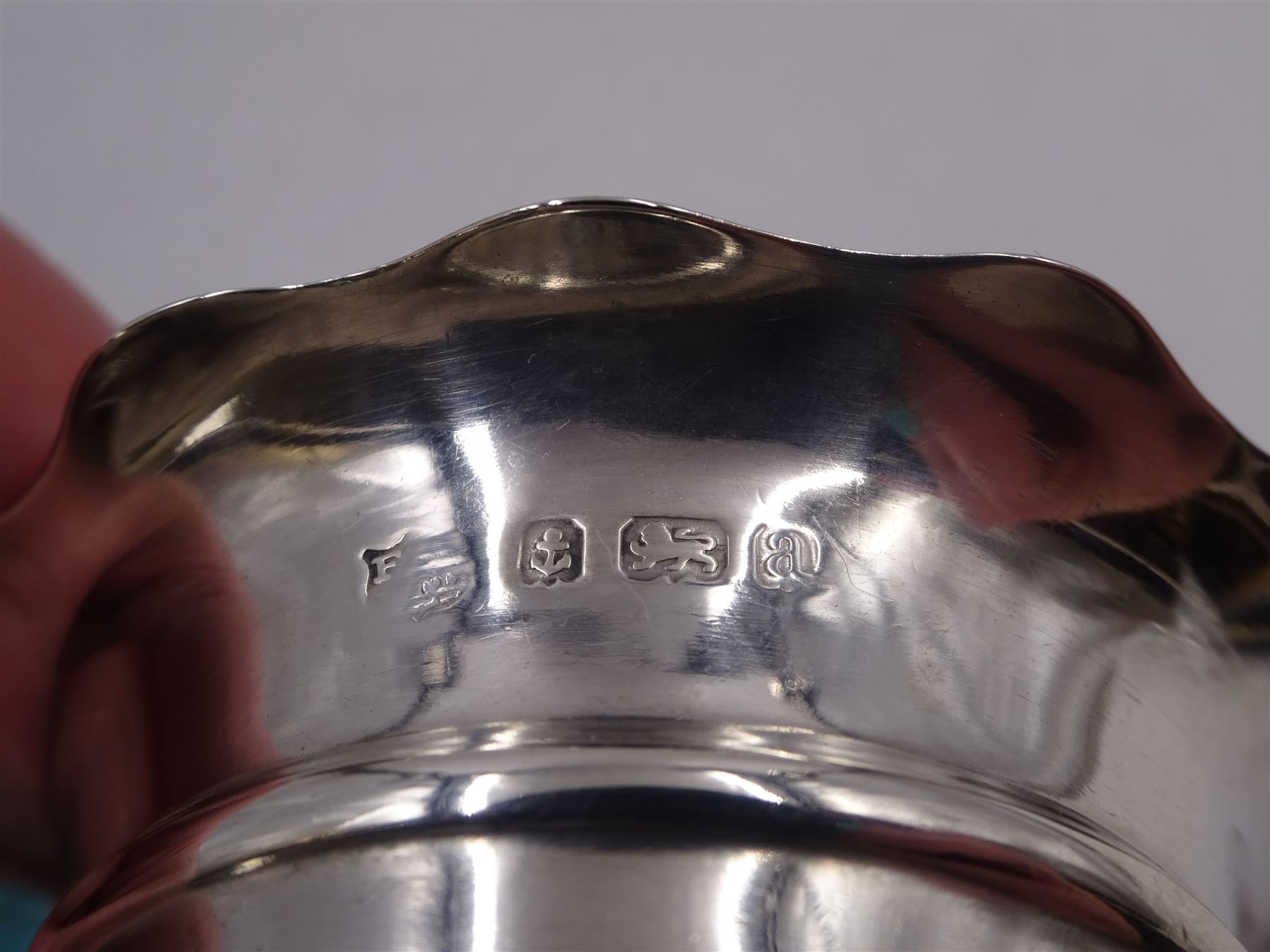 Pair of Victorian silver open salts, of circular form, with girdle and lobed rim, upon three shell mounted pad feet, hallmarked Fenton Brothers Ltd, Birmingham 1900, together with an early 20th century silver mustard pot and cover, of plain circular form, with C scroll handle, shaped rim and engraved initial to body, with knopped finial to slightly domed hinged cover, upon three pad feet, hallmarked Birmingham 1916, maker's mark worn and indistinct, together with a similar silver pepper shaker, hallmarked Birmingham 1911, maker's mark worn and indistinct