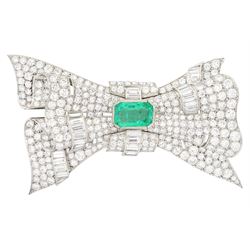 Platinum emerald and diamond bow brooch, central octagonal cut emerald of approx 4.00 cara...