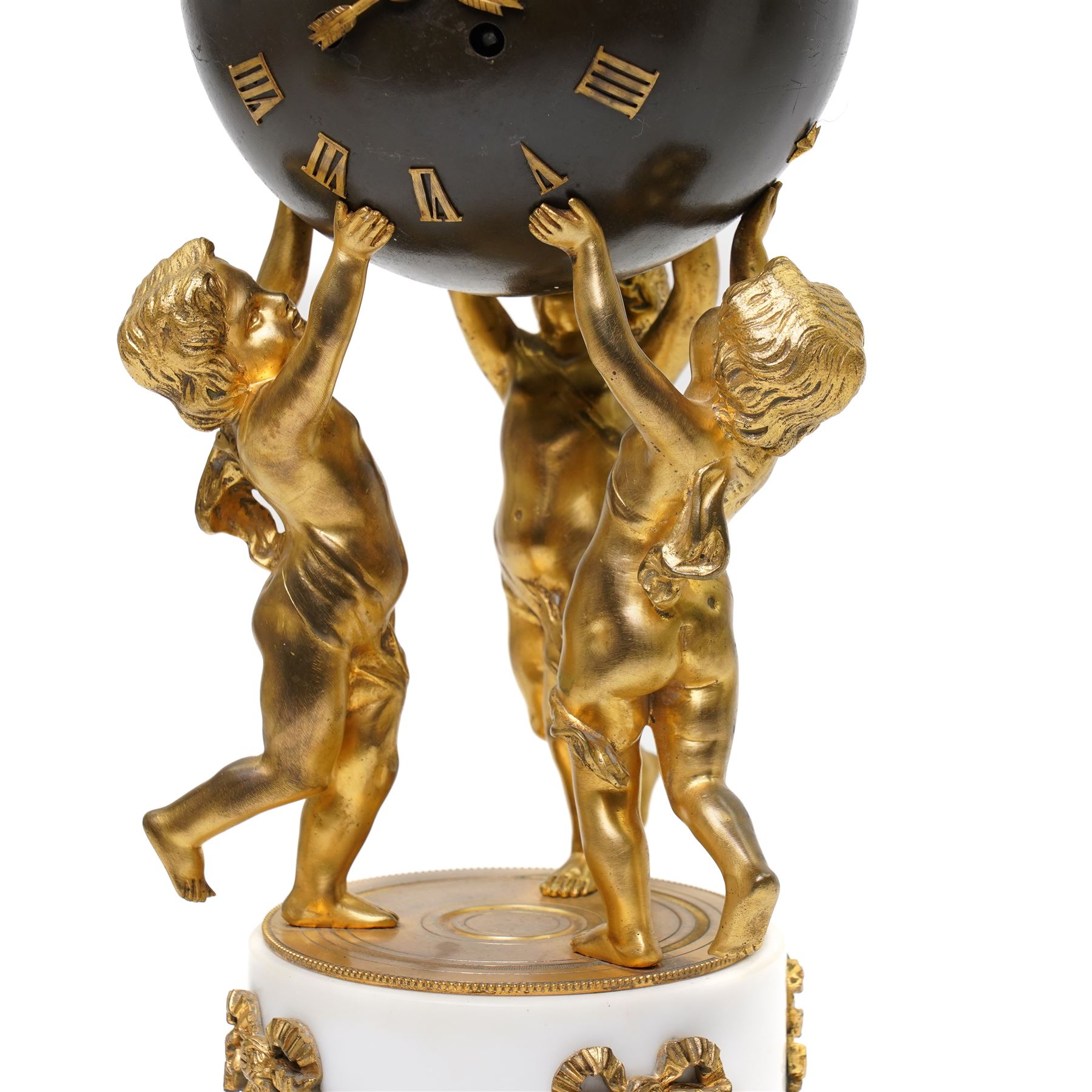 French- late 19th century 8-day globe clock, patinated globe with applied gilt Roman numerals, arrow-shaped hands and supported by three ormolu putti on a stepped columnar white marble base with a floral garland mount, twin train Parisian movement by Japy Freres with a recoil anchor escapement and countwheel strike, sounding the hours and half-hours on a bell. With pendulum.