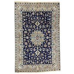  Central Persian Nain carpet, wool and silk inlaid, indigo ground field with central rosette floral medallion, decorated with interlaced branch and stylised plant motifs, repeating trailing floral design border 