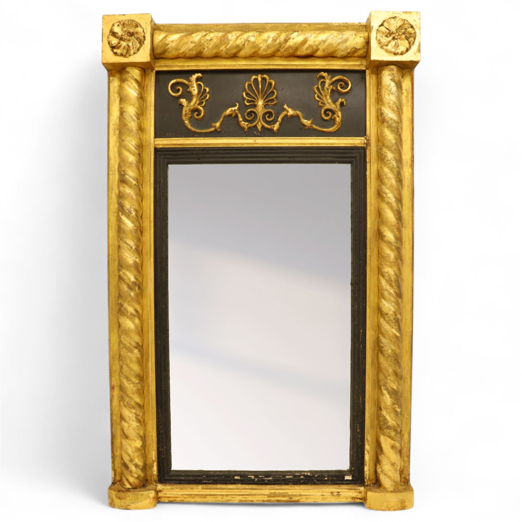 19th-century Regency-style ebonized and giltwood pier mirror, rectangular form frame with twisted rope columns on either side, ebonized frieze panel decorated with gilt applique scrollwork and central anthemion and arabesques