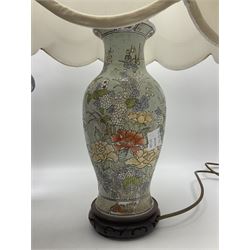 table lamp of baluster form decorated with flowers on a blue ground, upon a circular wooden base, together with another table lamp and a display shelf, shelf H69cm
