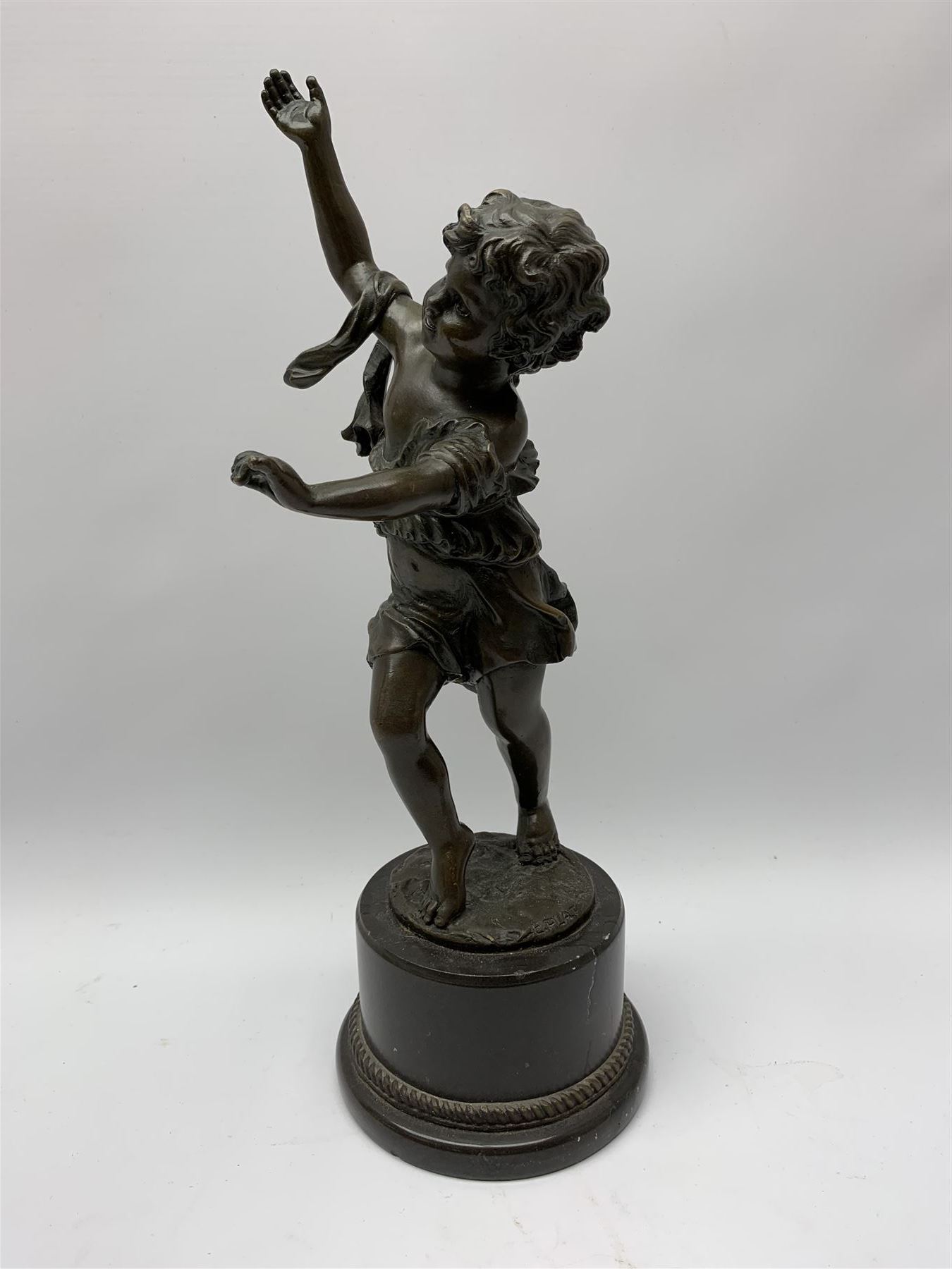 After E Plat, bronze modelled as a dancing child, signed E. Plat, upon cylindrical black marble base, H40cm