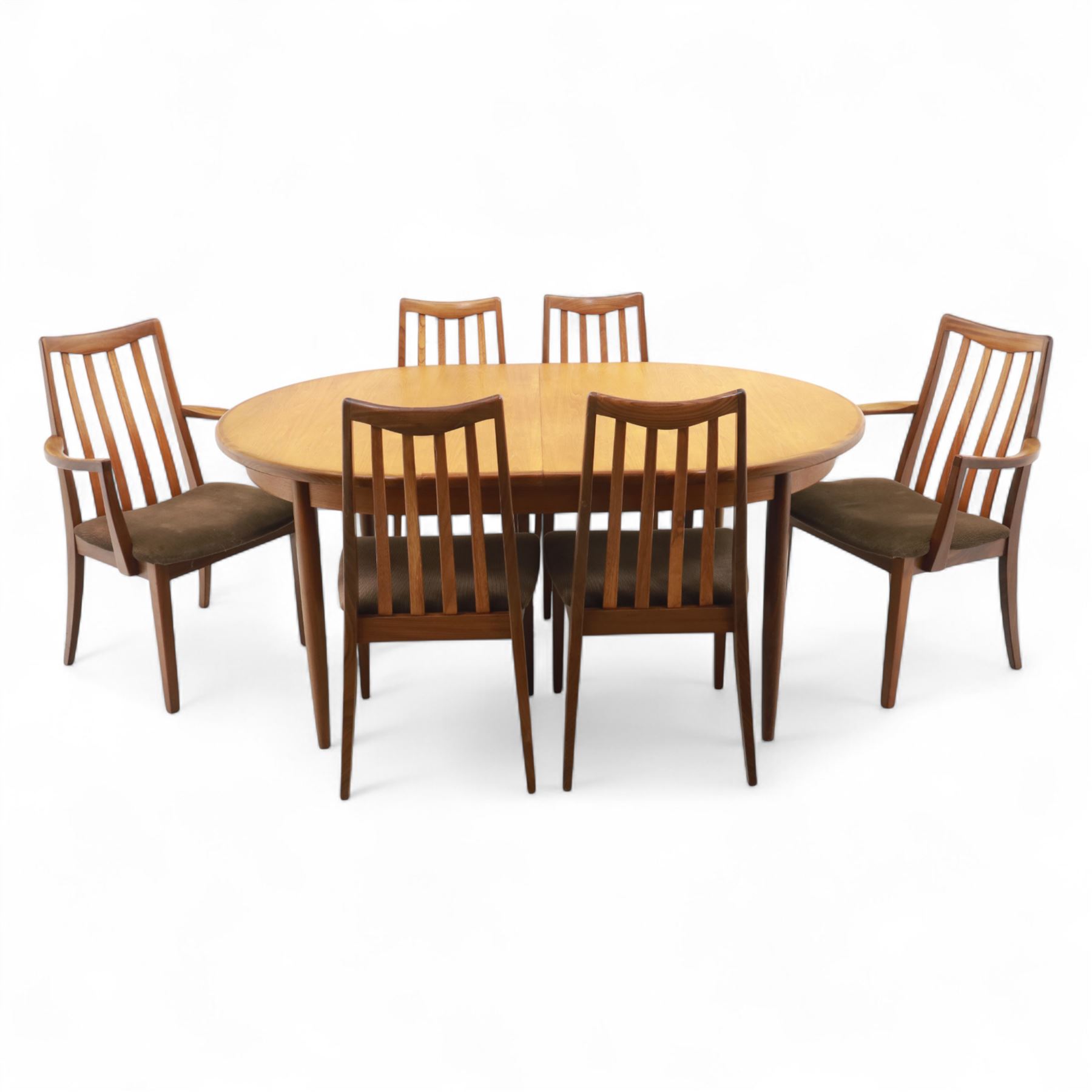 G Plan - mid-20th century teak extending dining table, oval top with integrated extension leaf, raised on tapering legs, together with a set of six slat back dining chairs including two carvers, upholstered in dark green velour (Extends to 210cm)