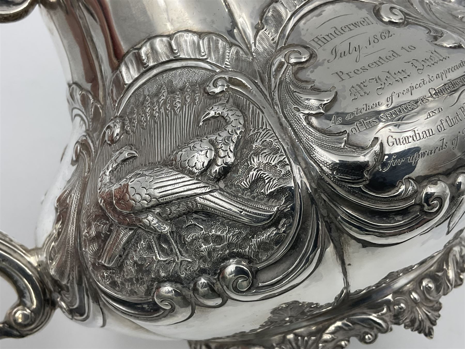 Victorian silver three piece tea service, comprising teapot, twin handled open sucrier, and milk jug, each of bellied form with acanthus capped scroll handles, the sides embossed with alternating scroll edged vacant panels and panels containing a pair of birds, upon four palmette feet, the teapot with ivory insulators to handle, and bird finial to the hinged domed cover, hallmarked William Hunter & Son, London 1861, teapot H19cm, including handles sucrier H13.5cm, including handle milk jug H12cm

This item has been registered for sale under Section 10 of the APHA Ivory Act