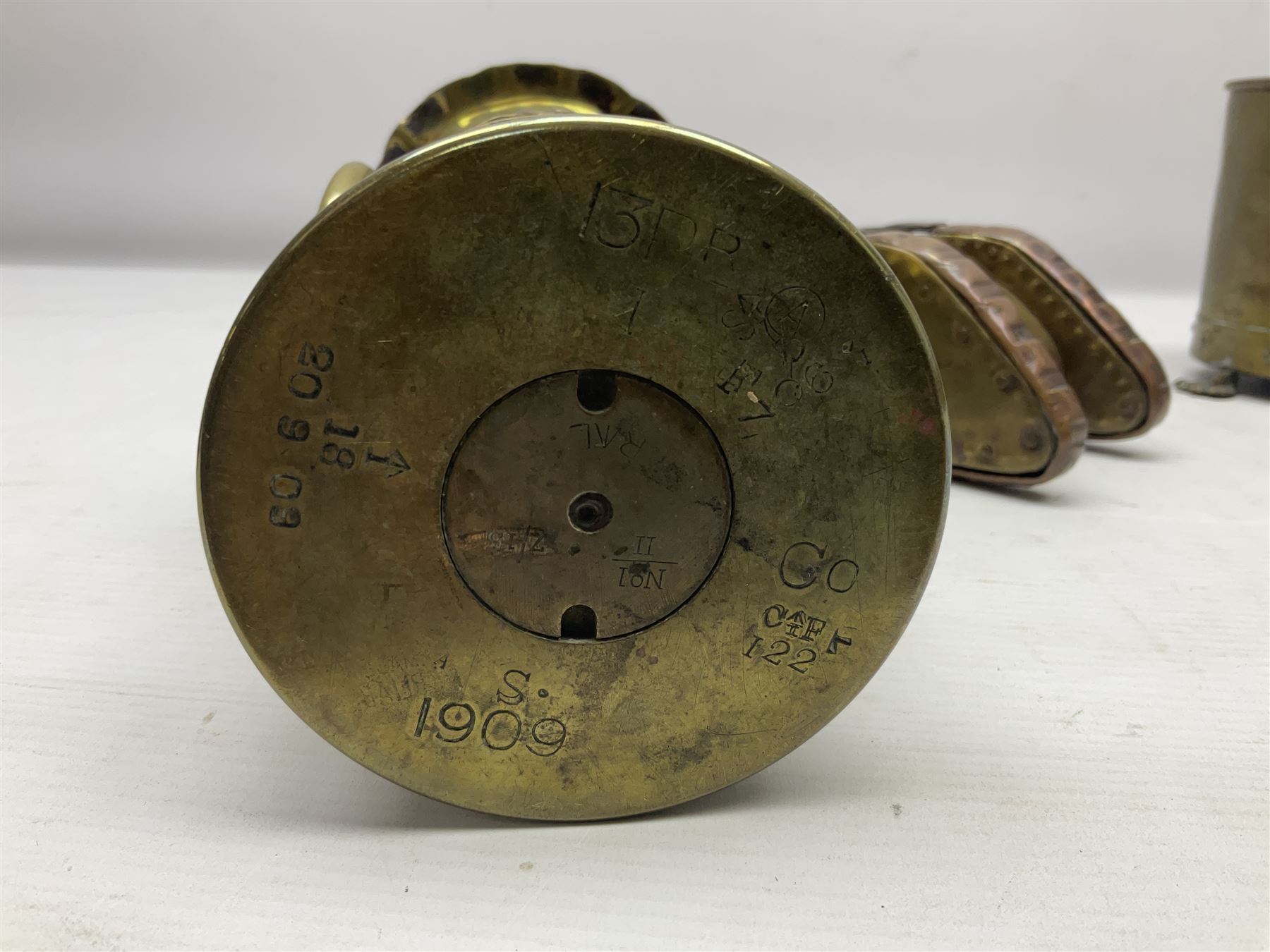 Trench Art - WWI 0-8-0 steam locomotive made from brass, copper and late Victorian pennies and half-pennies L17.5cm; WWI brass and copper tank candleholder; WWI brass shell case two-handled vase inscribed 'RFA France 1914-17'; and an unrelated brass plant holder (4)