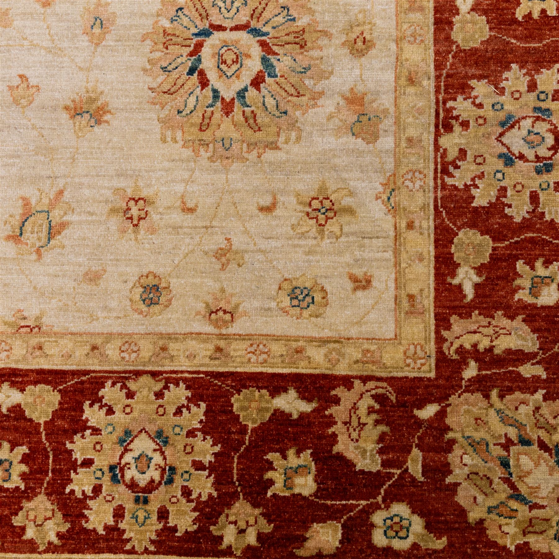 Indo-Persian Ziegler style Farahan design hand-knotted wool carpet, ivory field with open composition with dispersed palmettes, floral sprays and scrolling vinery with central subtle medallion enclosed within deep madder red border of complementary stylized foliate motifs