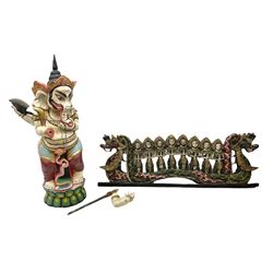 Balinese wood wall panel carved as a dragon boat with passengers, painted in reds and greens with gilding, together with a carved wood figure of Ganesh Deity decorated with gilt, raised upon circular lotus flower plinth, H78cm