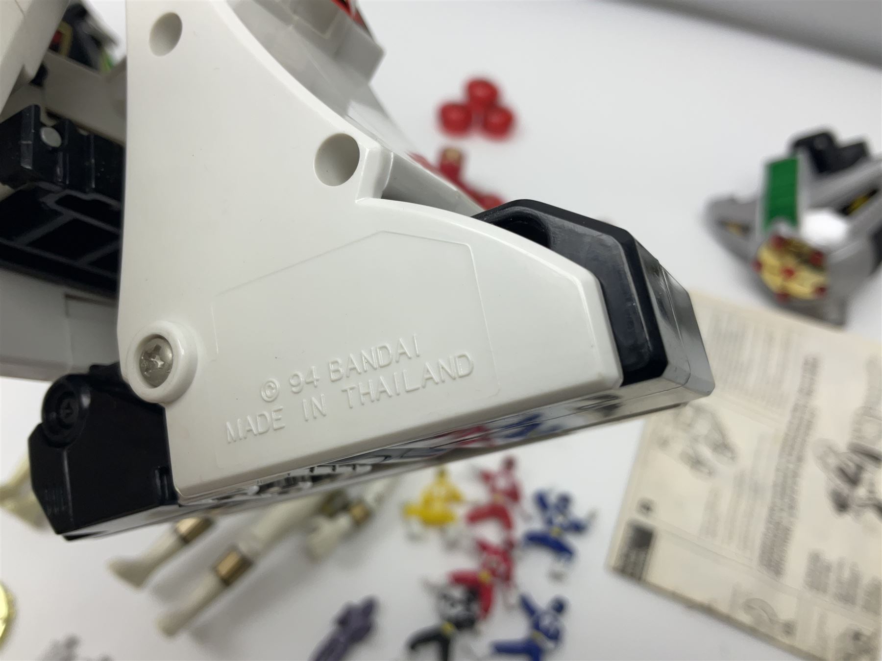 Collection of early 90s Mighty Morphin’ Power Rangers Zords, figures and accessories. Titanus the Carrier Zord, marked Bandai 1991; Green Dragonzord, incomplete; 1994 White Tigerzord with original instruction manual; 1993 Triceratops Dinozord, Mastodon Dinozord and Sabertooth Tiger Dinozord, Pterodactyl Dinozord, missing guns; with 1993 Power Morpher and original Power Coins, with further related figures, accessories and weapons