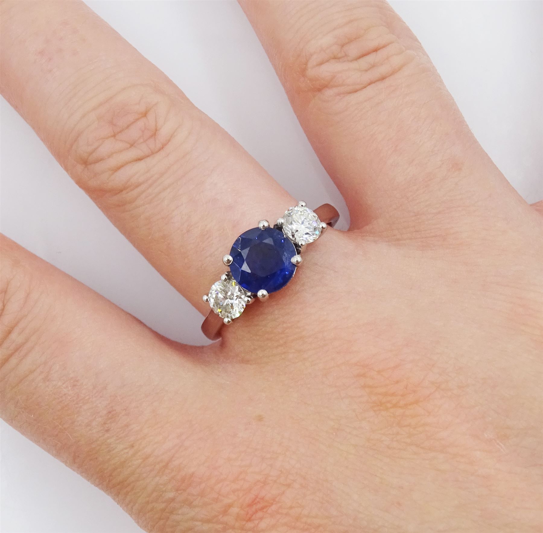 Platinum three stone sapphire and round brilliant cut diamond ring, sapphire approx 1.40 carat, total diamond weight approx 0.65 carat