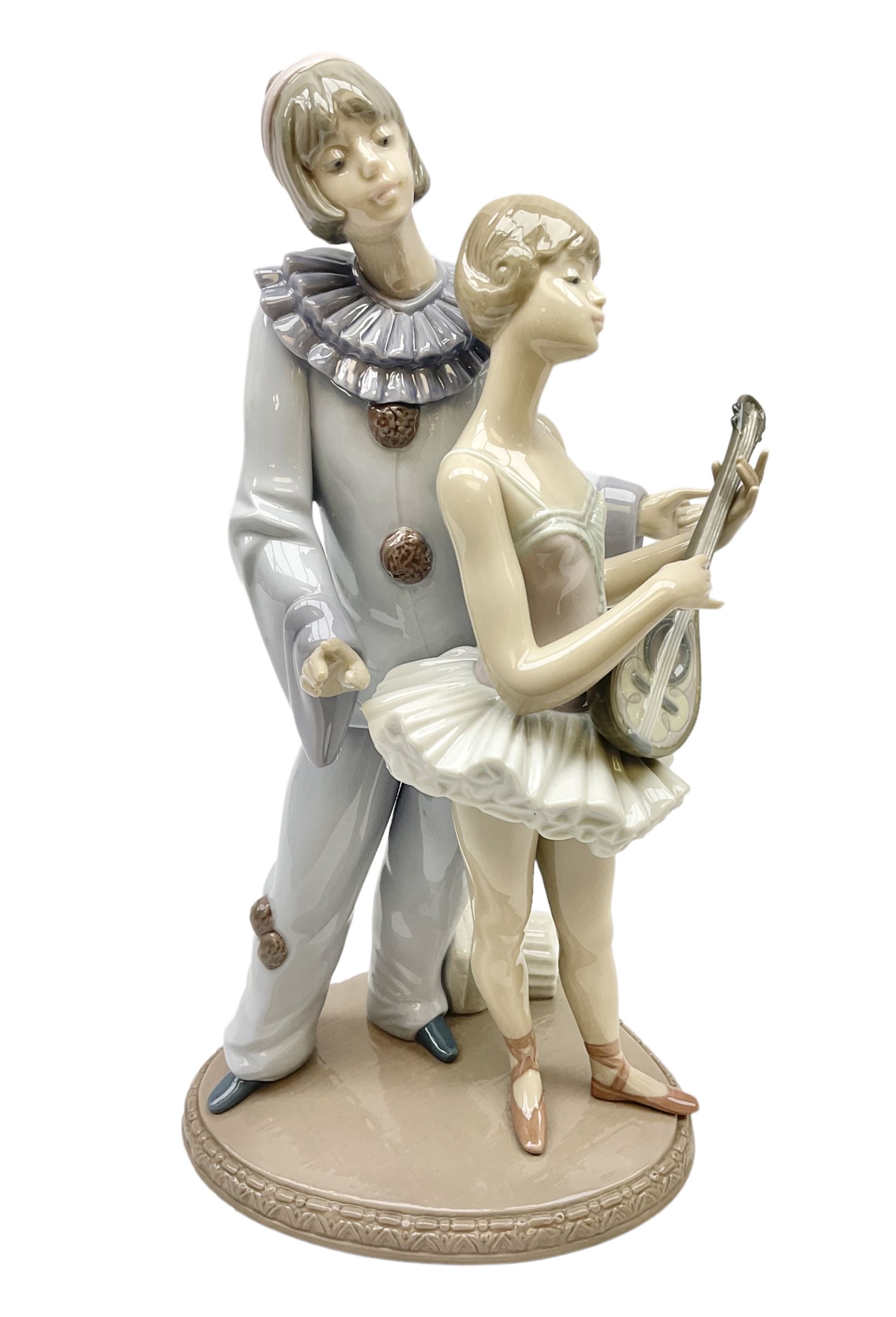Lladro figure, Minstrel's Love, modelled as a couple entertaining, the lady in ballerina costume playing the lute and the gent stood behind her in jester type dress, sculpted by Rafael Lozano, with original box, no 5821, year issued 1991, year retired 1993, H31cm