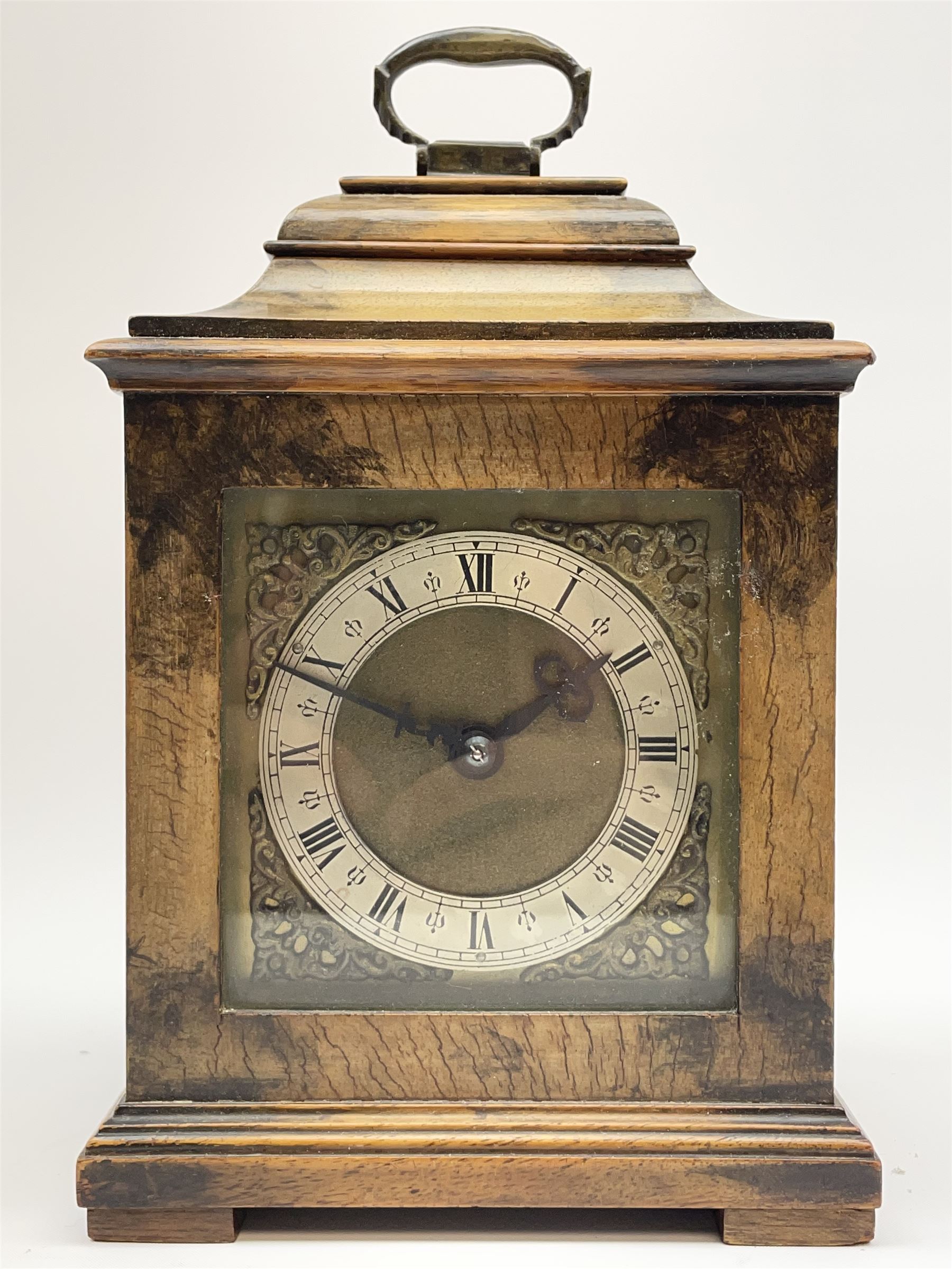 Small late 20th century walnut cased bracket clock. sarcophagus top with brass loop handle, brass dial with silvered Roman chapter ring and ornate spandrels, single train movement by 'Buren'