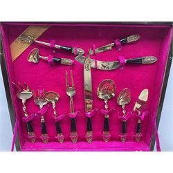 20th Century vintage Siamese cutlery canteen with gilt cutlery having dark wood handles and Buddha design terminals