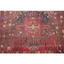 Four small Persian and Caucasian design rugs, comprising a Kazak rug with twin hooked medallions on a red ground, Baluchi rug with geometric motifs on a muted red ground, Shiraz rug with a central ivory and red medallion on a blue ground, and a Bokhara mat with four guls on a rose ground, each enclosed by geometric borders, largest 143cm x 88cm (4)