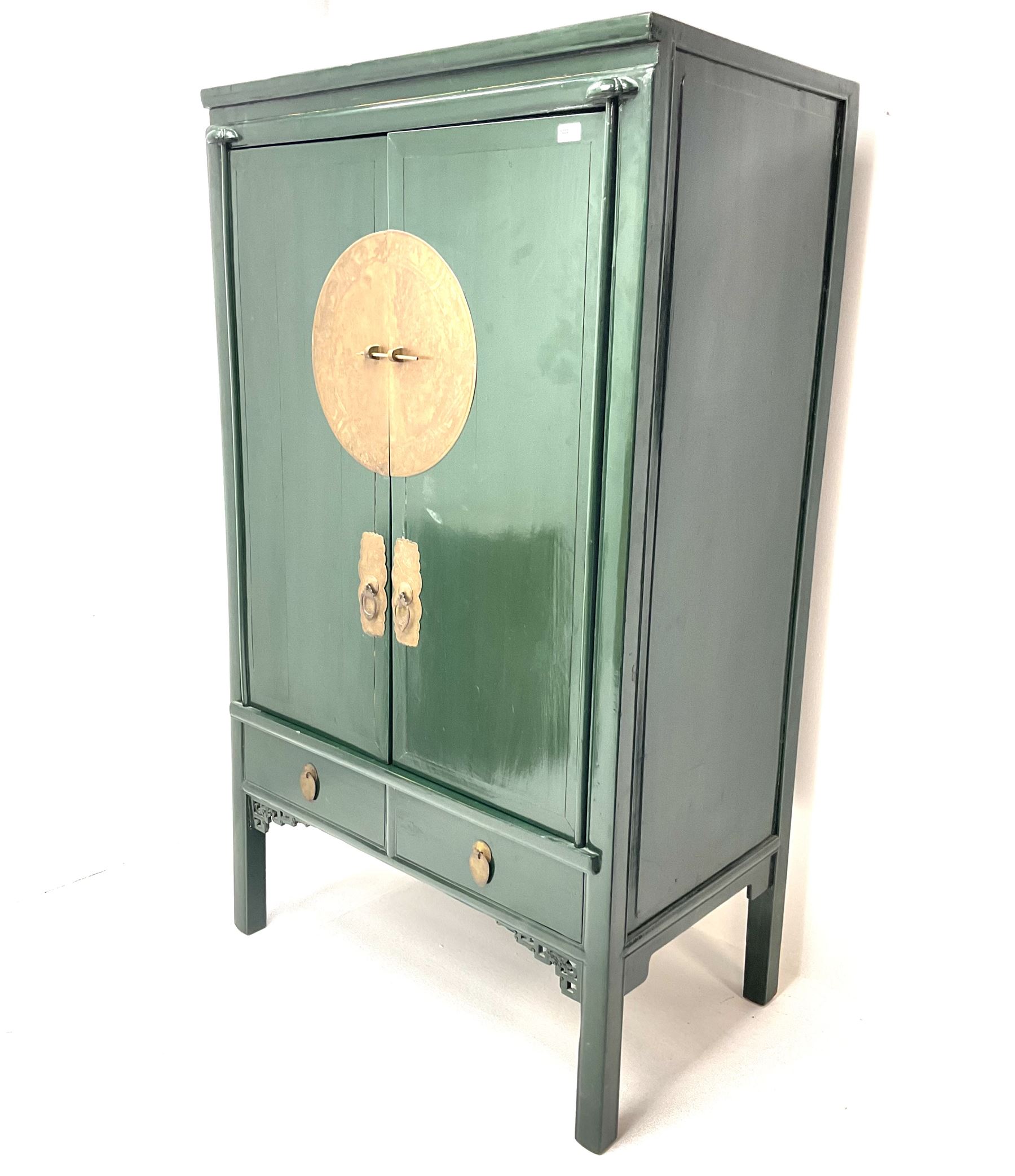 Chinese 'moon' rosewood raised cabinet, hammered brass centre piece featuring floral design, two cupboard doors enclosing two tiers and two short drawers, above two short drawers, shaped trim and stile supports 