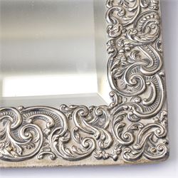 Late Victorian silver mounted dressing table mirror, the frame decorated with scrolls and oval cartouche initialled 'C', bevelled plate on an easel stand 57cm x 38cm London 1899 Maker Charles Henry Dumenil 