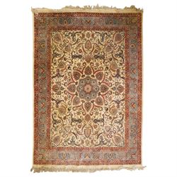 Persian Isfahan ivory and crimson ground rug, the busy field with central floral pole meda...