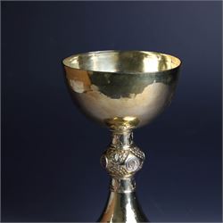 Mid 20th century silver-gilt chalice, the goblet with hammered finish upon knopped stem, the knop embossed with symbols and foliate decoration, engraved to base ' veni non ministrari sed ministrare' and with presentation engraving to underside, hallmarked Guild of Handicraft, London 1957, H17cm