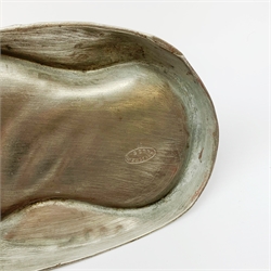 A Kayserzinn Art Nouveau pewter ink stand and pen tray, designed by Hugo Leven, of shaped oval form detailed with stylised tendrils, the hinged inkwell cover opening to reveal an amethyst glass liner, marked beneath Kayserzinn 4438, L21cm.