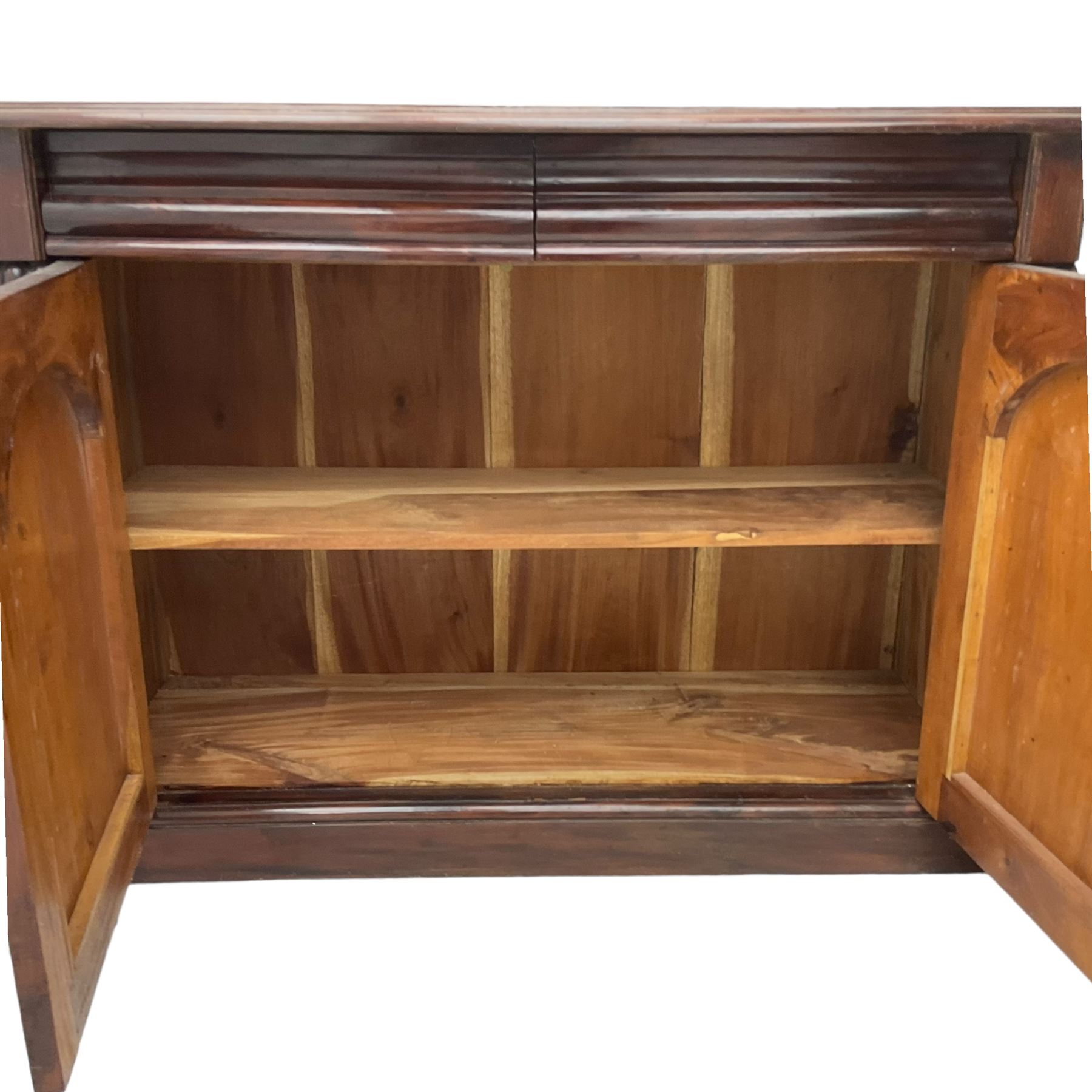 Victorian mahogany chiffonier, raised shaped back with foliage scroll carved mounts, on fretwork and carved bracket supports, moulded rectangular top over two frieze drawers and double panelled cupboard, on moulded plinth base