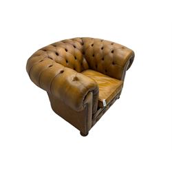 Chesterfield armchair, upholstered in buttoned tan leather with studded detail, on turned feet