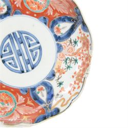 Group of 19th century Japanese Imari porcelain, Meiji period, comprising pair of lobed dishes, decorated stylised reserves and painels in blue and gilt upon a red ground, H6.5cm D21.5cm, a pair of plates of circular lobed form, decorated with a central panel depicting a vase beneath pine branches, and surrounded by panels of flowers and stylised quatrefoil shapes, D21cm, and another similar example painted with a character in underglaze blue to the centre, with character mark beneath, D22cm, each with character marks beneath               