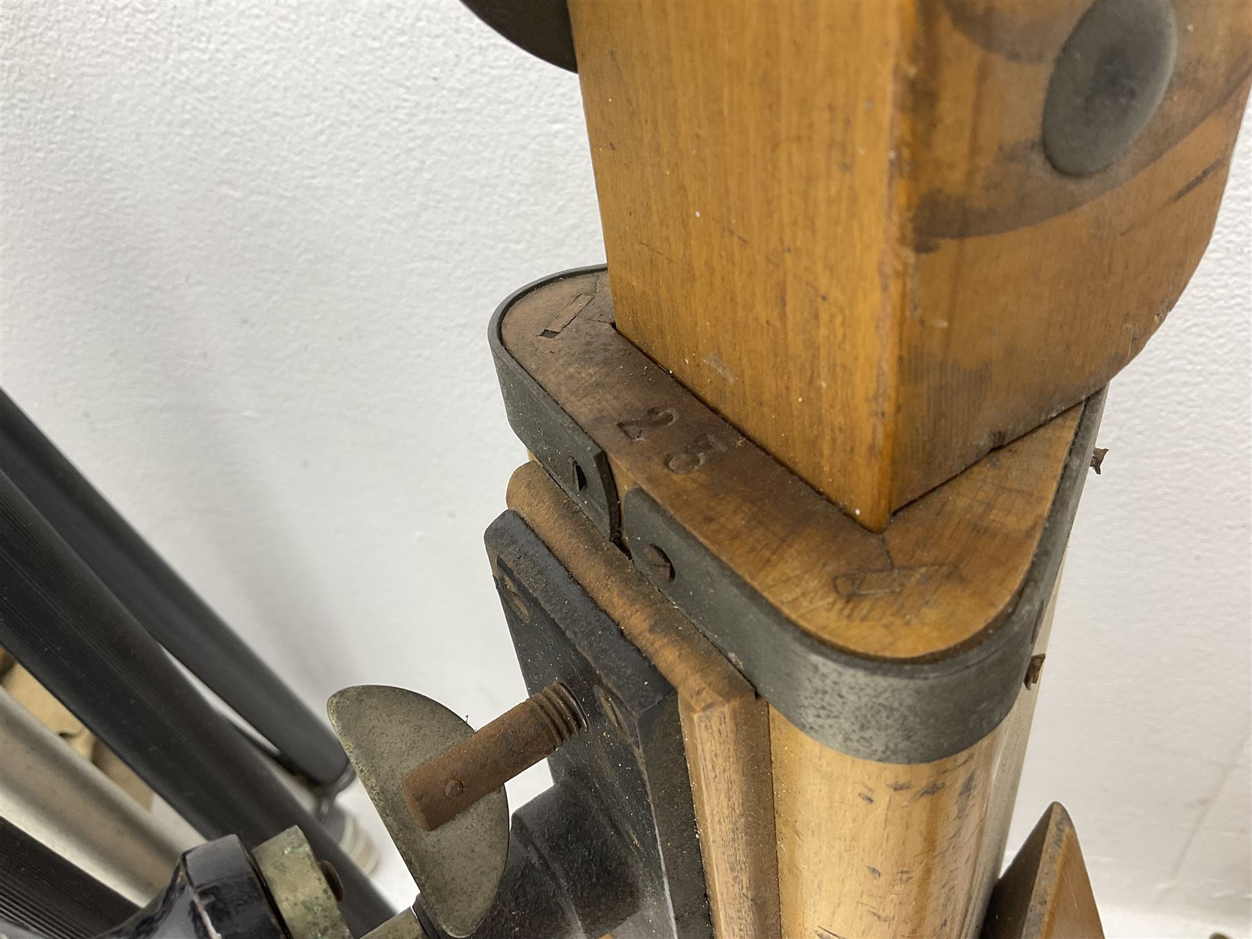 Three wooden adjustable tripods for plate cameras, together with a Linhof of Munchen metal tripod in a canvas case 