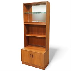 G-Plan - ‘Fresco’ teak bookcase cabinet, rectangular open bookcase with mirrored back panel to the upper section, fitted with a single glass display shelf and two wooden shelves below, the base enclosed by a pair of cupboard doors with shaped teak handles, on a plinth base