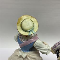 Pair of late 19th/early 20th Century Meissen figures, modelled as flower sellers, after the original by Michel Victor Acier, she holding basket of flowers, he holding flowers in his hat, each with underglaze cross swords mark beneath, tallest H16.5cm