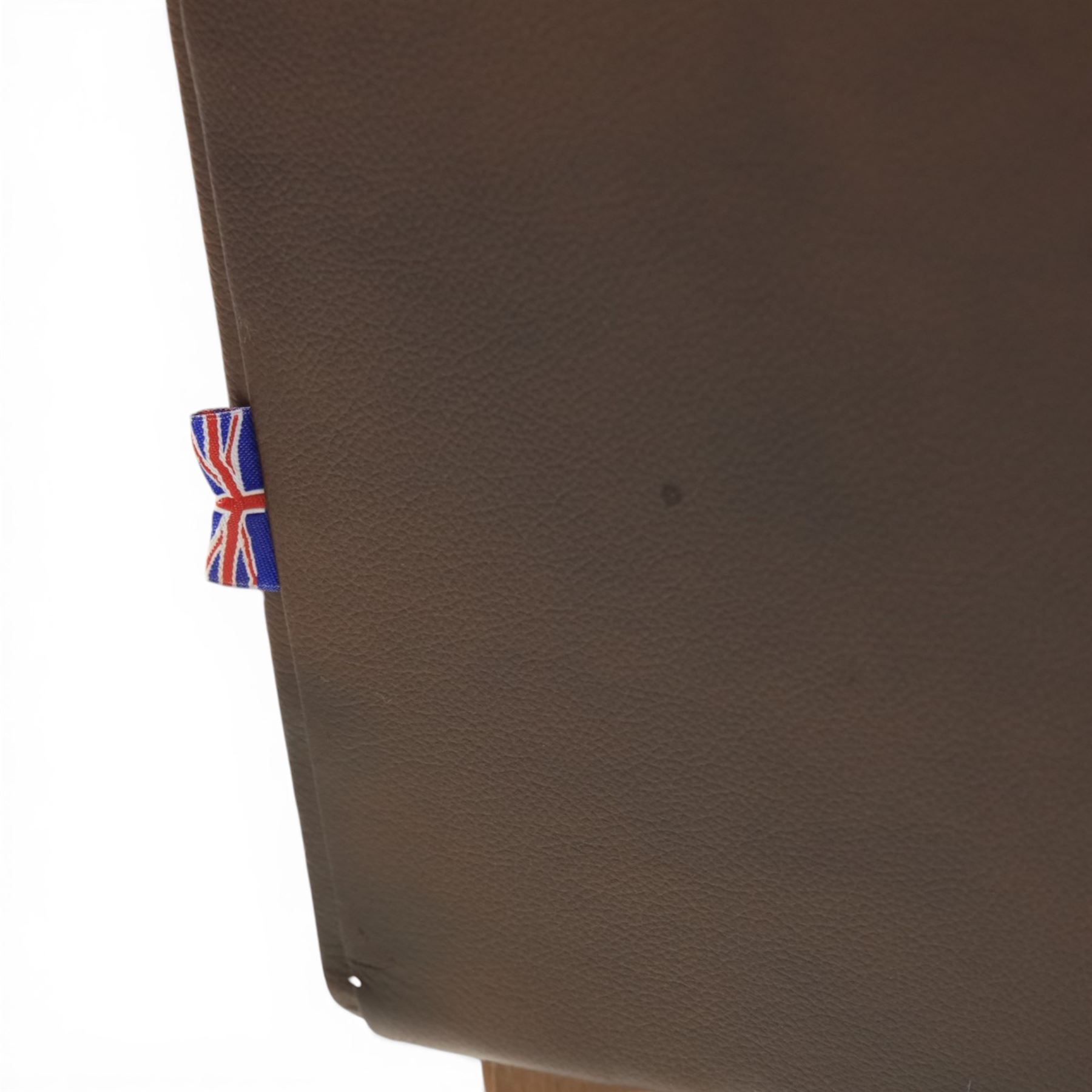 Marks & Spencer - Pair of brown leather wing back chairs, raised on light stained supports with castors