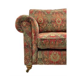 Duresta - 'Beaminster' grande two-seat sofa, traditional shape with rolled arms, upholstered in 'Althorp' russet and stone floral pattern fabric, on turned feet with brass castors
