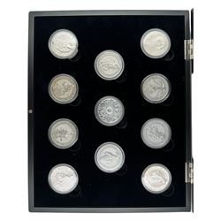 Eleven Queen Elizabeth II 'Queen's Beasts' two ounce fine silver coins, including 2016 'Lion of England', 2017 'Griffin of Edward', 2018 'Black Bull of Clarence' etc, housed in a display case