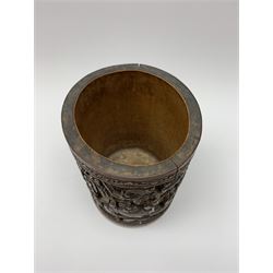 Late 19th century Chinese bamboo brush pot, densely carved with scholars, attendants, and maidens or meiren, within a landscape filled with rocky outcrops, pavilions and trees, with painted character mark beneath, H17cm D12cm

